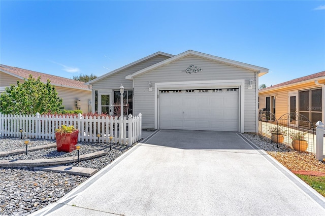 ranch-style home featuring driveway, an attached garage, and fence