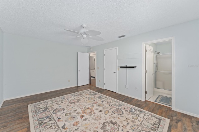 bedroom featuring a textured ceiling, wood finished floors, visible vents, and baseboards