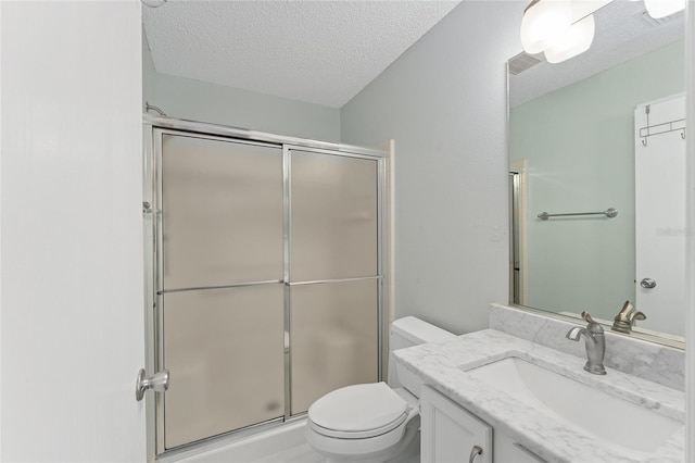 full bath with a shower with door, visible vents, toilet, a textured ceiling, and vanity