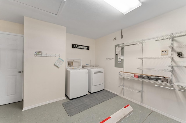 washroom featuring laundry area, electric panel, baseboards, and washer and dryer