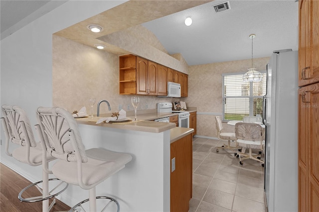 kitchen with white appliances, visible vents, brown cabinetry, vaulted ceiling, and open shelves