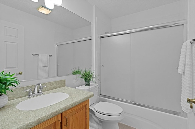 bathroom with toilet, a textured ceiling, vanity, and bath / shower combo with glass door