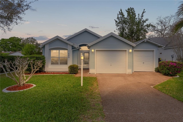 single story home featuring concrete driveway, a front lawn, and an attached garage