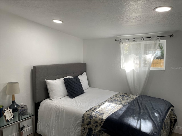 bedroom featuring recessed lighting and a textured ceiling