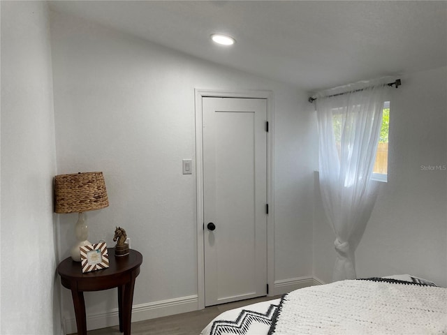 bedroom with recessed lighting, a closet, baseboards, and wood finished floors