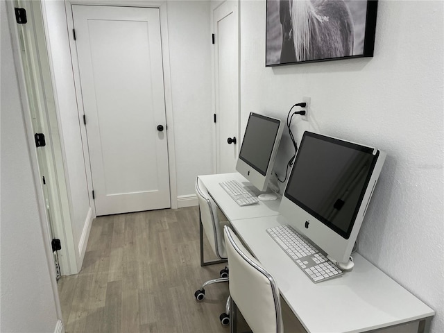 office featuring light wood-type flooring and baseboards