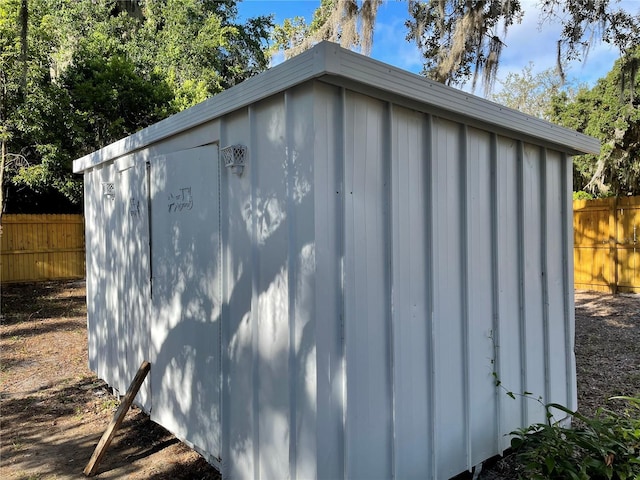 view of shed featuring fence