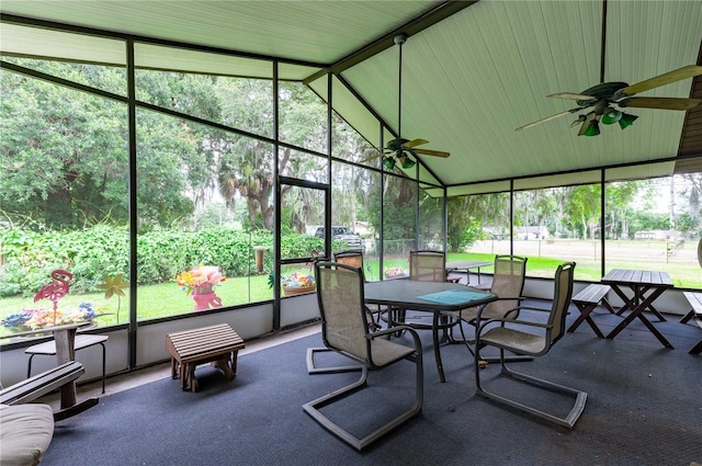 sunroom featuring ceiling fan, lofted ceiling, and a healthy amount of sunlight