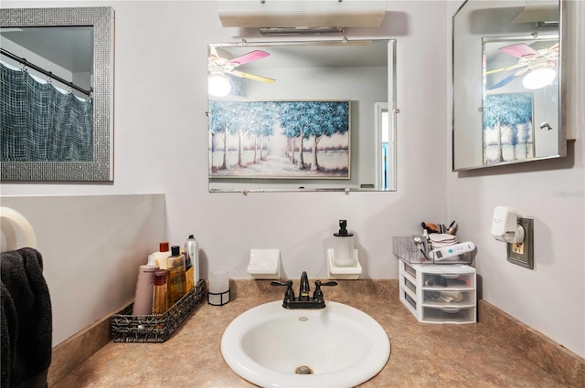 bathroom featuring a shower with curtain, ceiling fan, and a sink