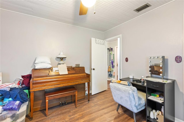 office with ceiling fan, visible vents, and wood finished floors