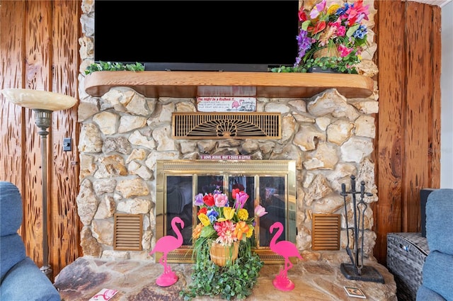 details featuring a stone fireplace and visible vents