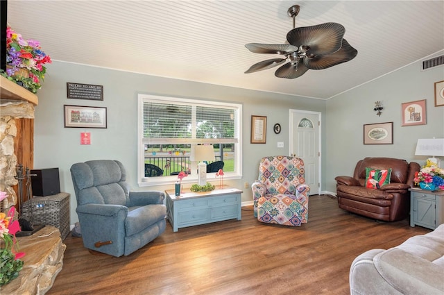 living area with visible vents, light wood-style flooring, a ceiling fan, vaulted ceiling, and baseboards