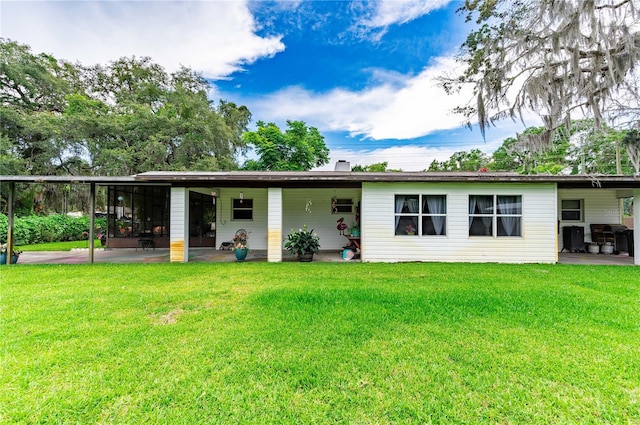 back of property with a patio and a yard