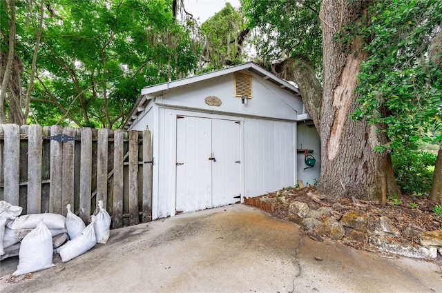 view of shed featuring fence