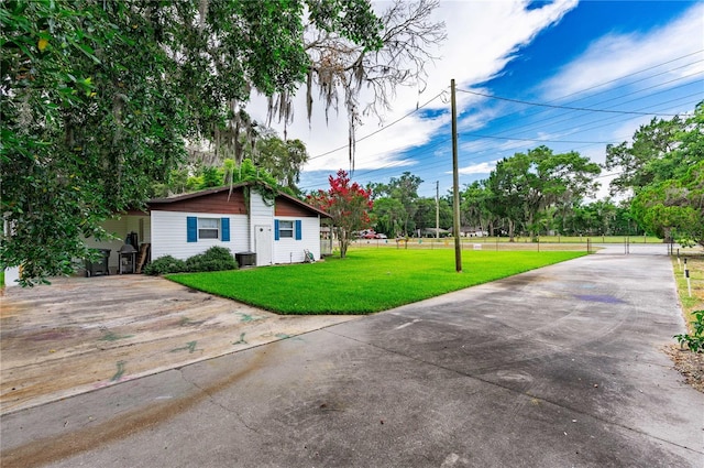 exterior space featuring central AC and a front yard