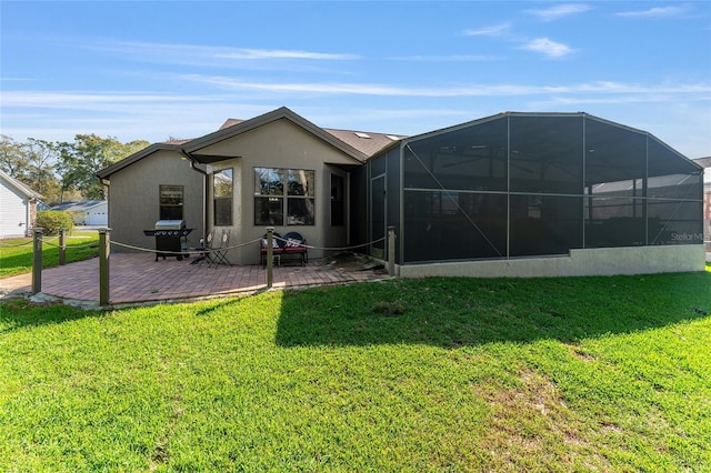 rear view of property with a lanai, a patio, a lawn, and stucco siding