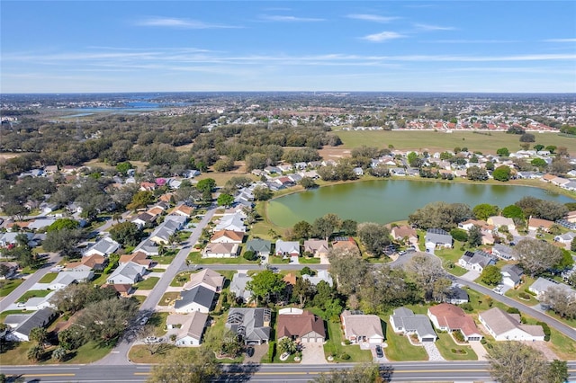 drone / aerial view with a water view and a residential view