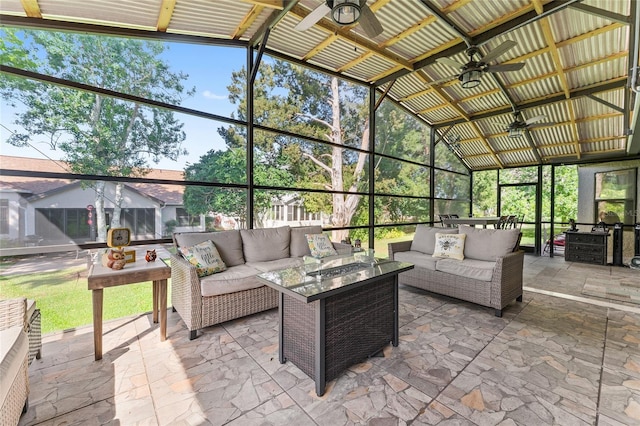 view of patio with ceiling fan, glass enclosure, and outdoor lounge area