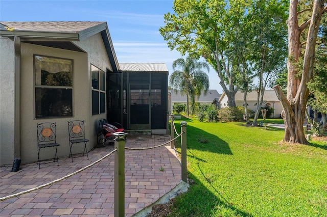 view of yard featuring a patio area and a sunroom