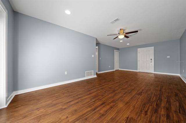 unfurnished room with visible vents, wood finished floors, baseboards, and ceiling fan