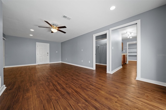 empty room featuring visible vents, recessed lighting, baseboards, ceiling fan, and dark wood-style flooring