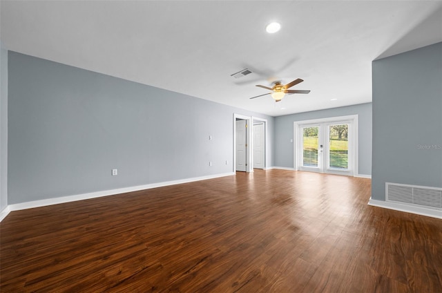 empty room featuring visible vents, baseboards, a ceiling fan, and wood finished floors