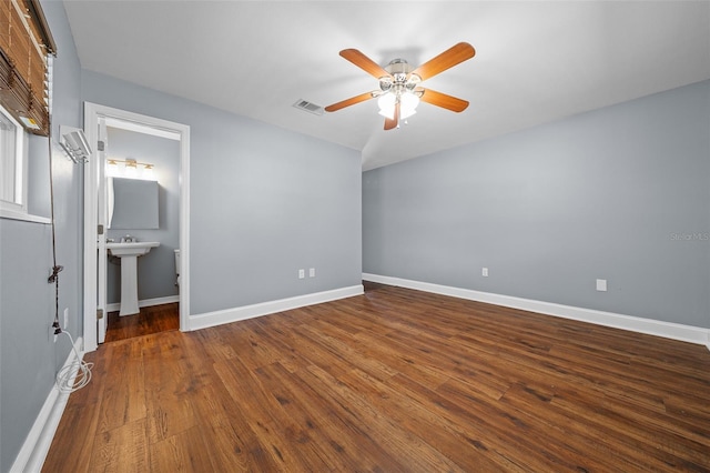 unfurnished bedroom with ceiling fan, visible vents, baseboards, and wood finished floors