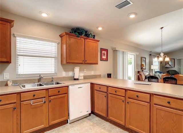 kitchen with light countertops, visible vents, dishwasher, and a sink