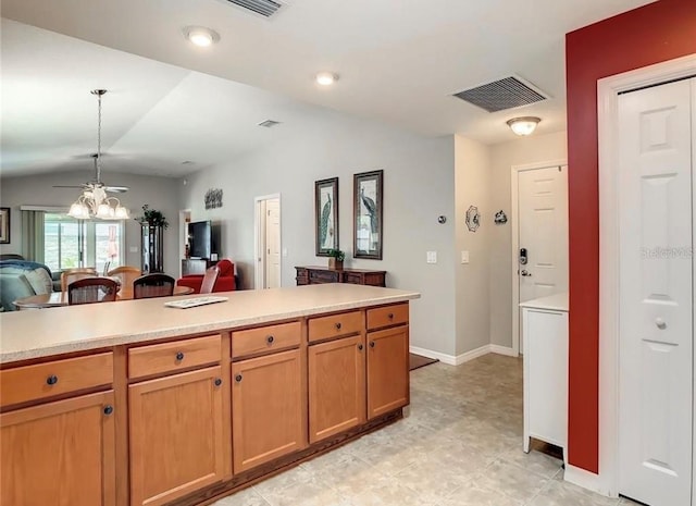 kitchen featuring vaulted ceiling, visible vents, open floor plan, and light countertops