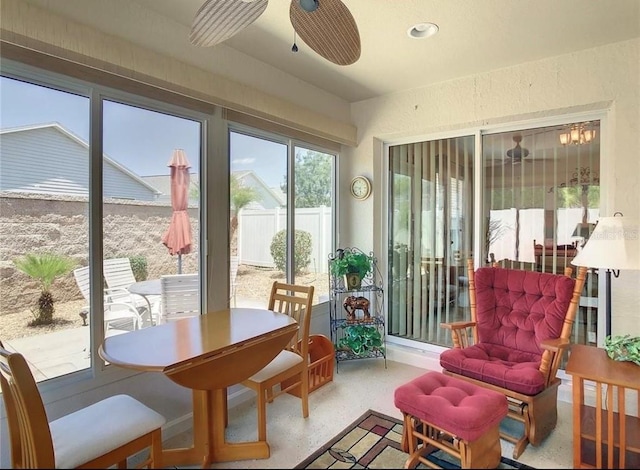 sunroom / solarium with a ceiling fan