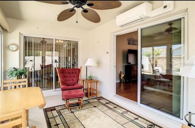 sunroom / solarium featuring ceiling fan and a wall mounted AC