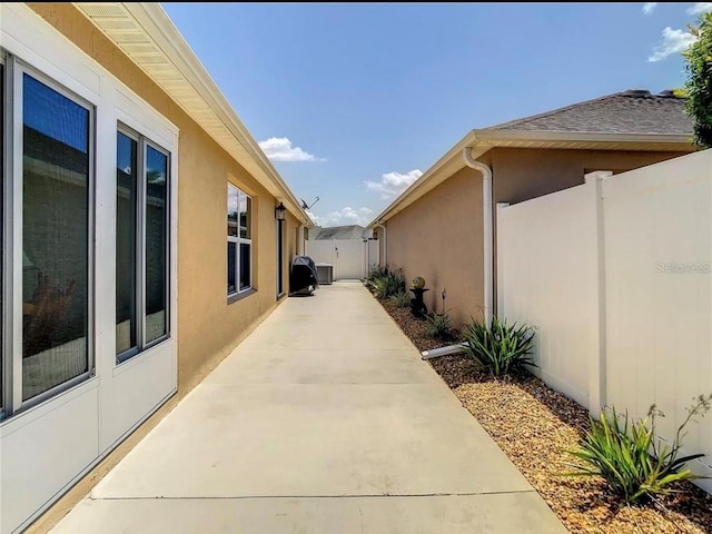 view of home's exterior featuring a patio area, fence, and stucco siding