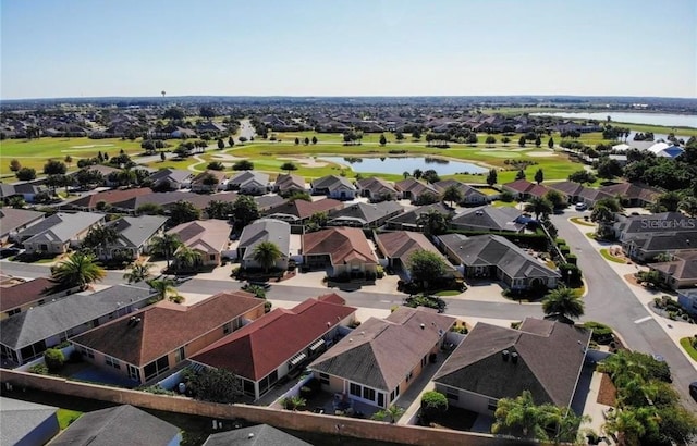 birds eye view of property with a residential view, view of golf course, and a water view