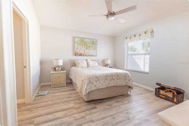 bedroom featuring baseboards, ceiling fan, and light wood finished floors