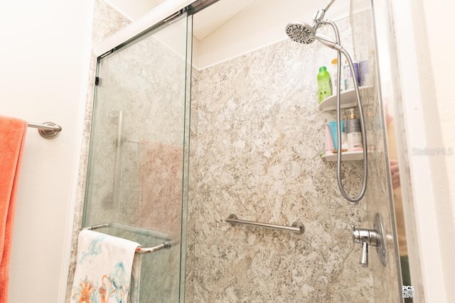 bathroom with a shower stall