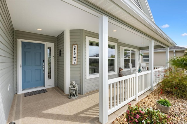 view of exterior entry with a porch