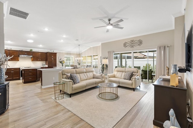 living area featuring light wood finished floors, ceiling fan, ornamental molding, and visible vents