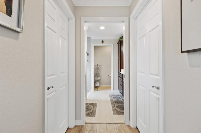 hallway with light wood finished floors and baseboards