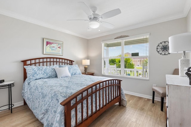 bedroom with ornamental molding, light wood-type flooring, a ceiling fan, and baseboards