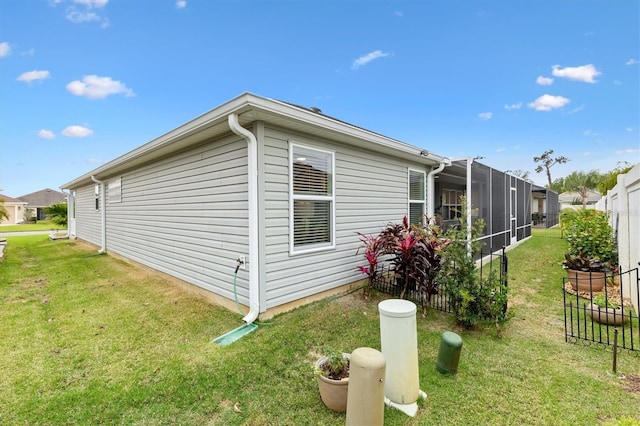 view of home's exterior featuring fence and a yard