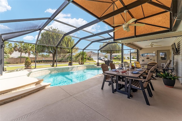 pool with a patio area, outdoor dining area, a ceiling fan, and a lanai