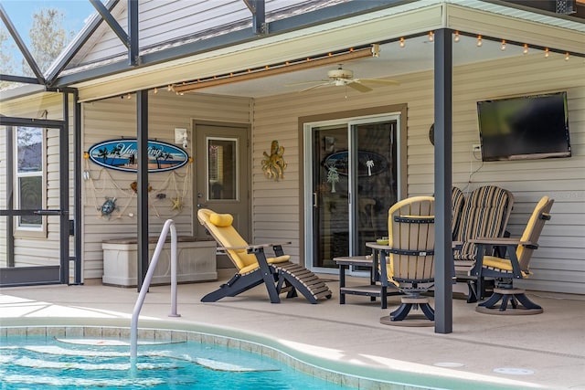 pool featuring glass enclosure, a patio, and a ceiling fan