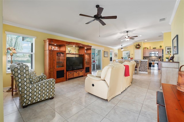 living room featuring visible vents, lofted ceiling, light tile patterned flooring, ceiling fan, and crown molding