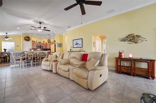 living room featuring crown molding, light tile patterned floors, baseboards, and visible vents