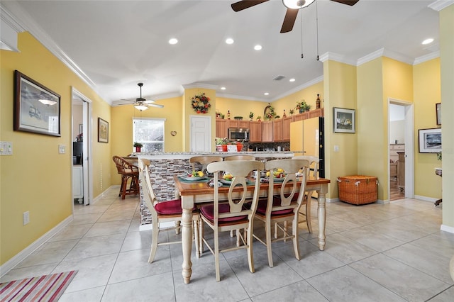 dining room featuring light tile patterned floors, visible vents, crown molding, and baseboards