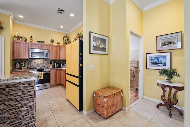 kitchen featuring visible vents, light tile patterned flooring, ornamental molding, decorative backsplash, and appliances with stainless steel finishes