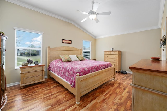 bedroom featuring lofted ceiling, multiple windows, light wood-style floors, and ornamental molding