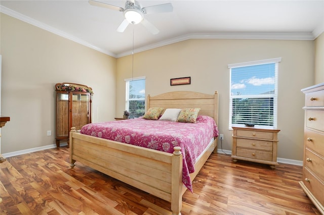 bedroom with vaulted ceiling, light wood-style flooring, and crown molding