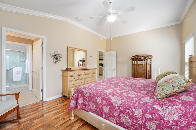 bedroom featuring light wood finished floors, visible vents, baseboards, lofted ceiling, and ornamental molding