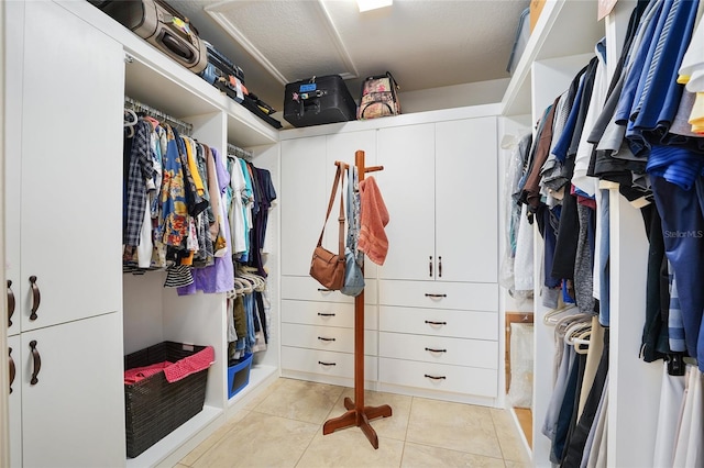 spacious closet with light tile patterned flooring